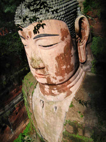 Many people stand on the foot of Leshan Giant Buddha.