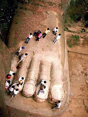 Many people stand on the foot of Leshan Giant Buddha.