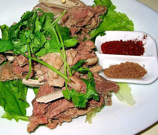 hand grasping sheep meat